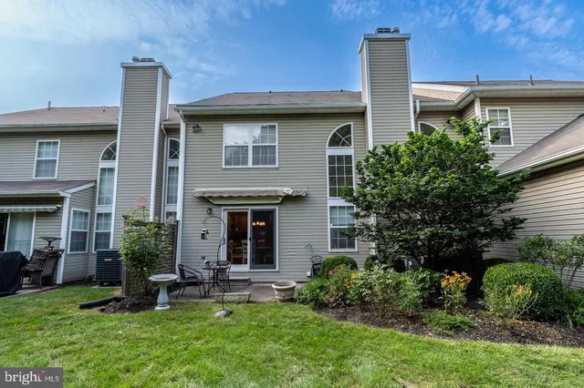 a view of a house with sitting area and garden