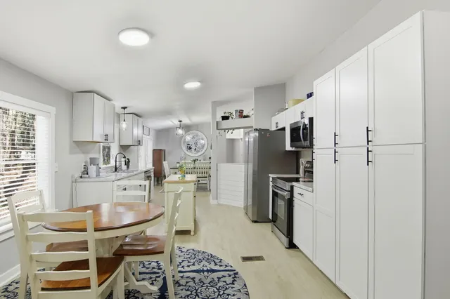 a kitchen with stainless steel appliances a refrigerator stove and sink