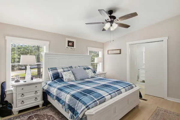 a bedroom with a large bed and a chandelier