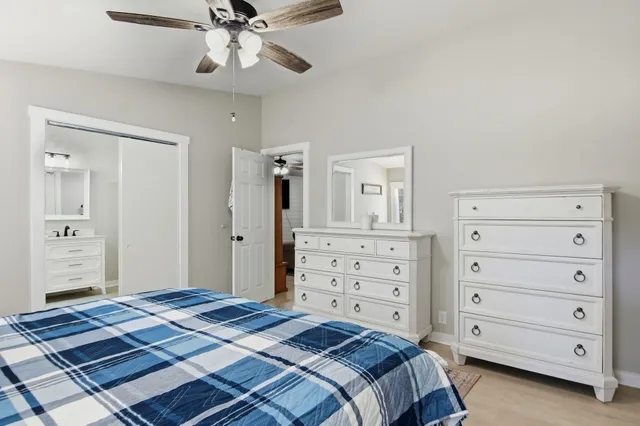 a bedroom with a bed and a dresser