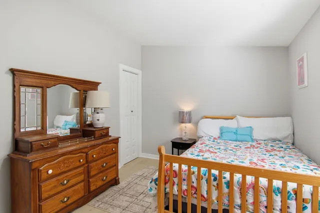 a bedroom with a bed and a dresser