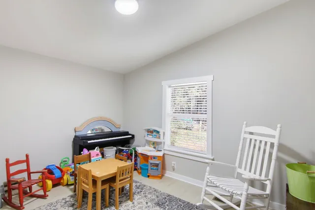 a children room with furniture and a window