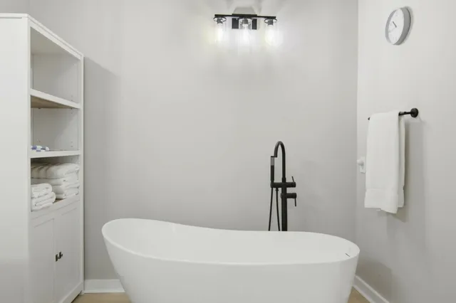 a white bath tub sitting in a bathroom