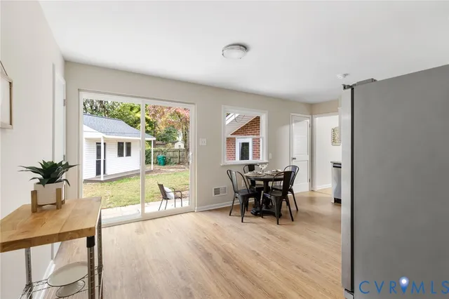 a view of a dining room with furniture window and wooden floor