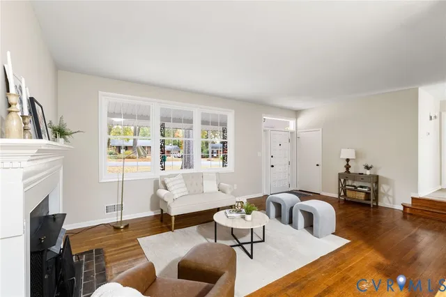 a living room with furniture fireplace and a table