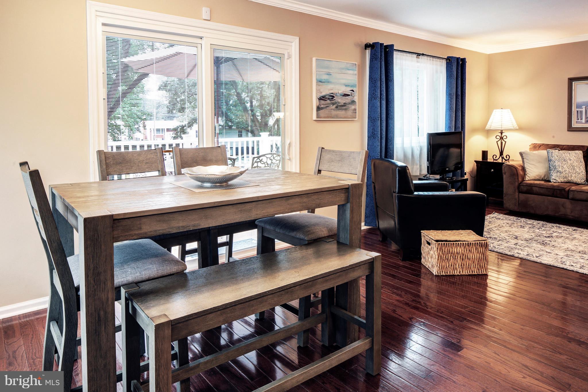 765 Evergreen Road Severn, MD 21144 - Photo 5 of 23 a view of a dining room with furniture window and wooden floor