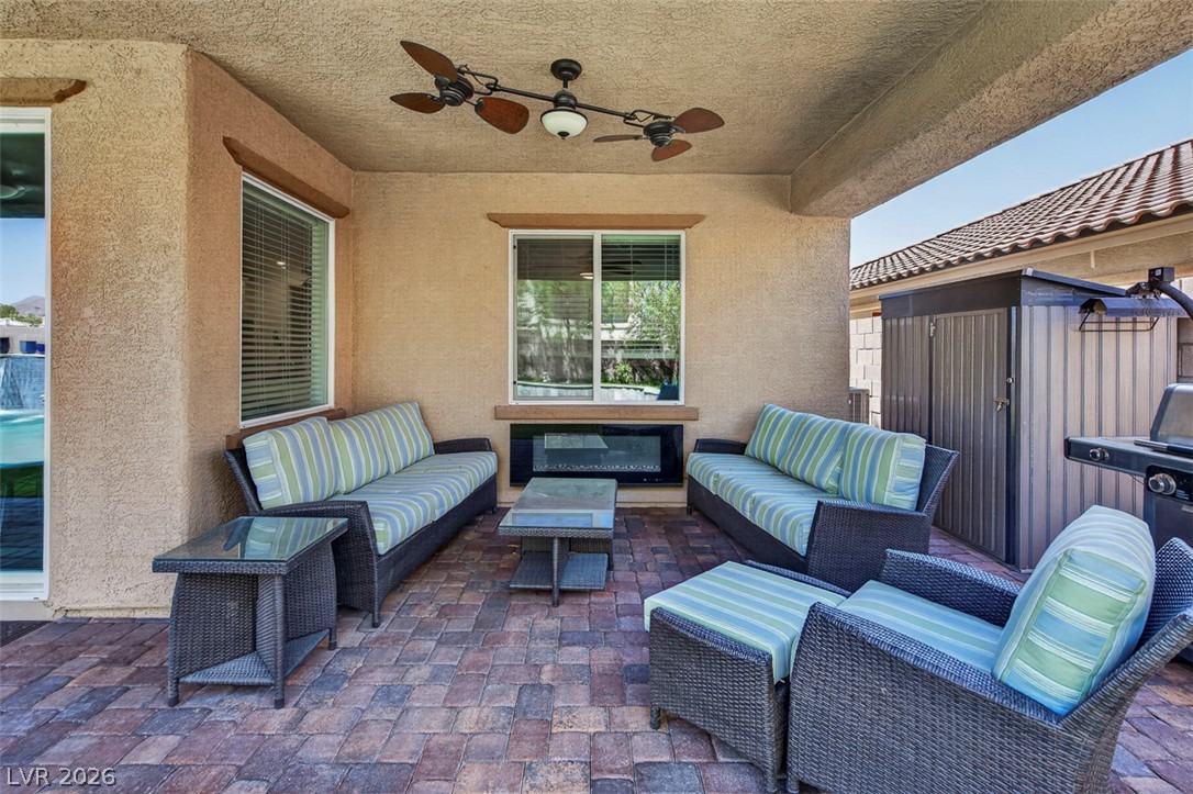 1824 Redland Ridge Street Henderson, NV 89002 - Photo 62 of 69 An inviting outdoor living area with fireplace for evening gatherings.