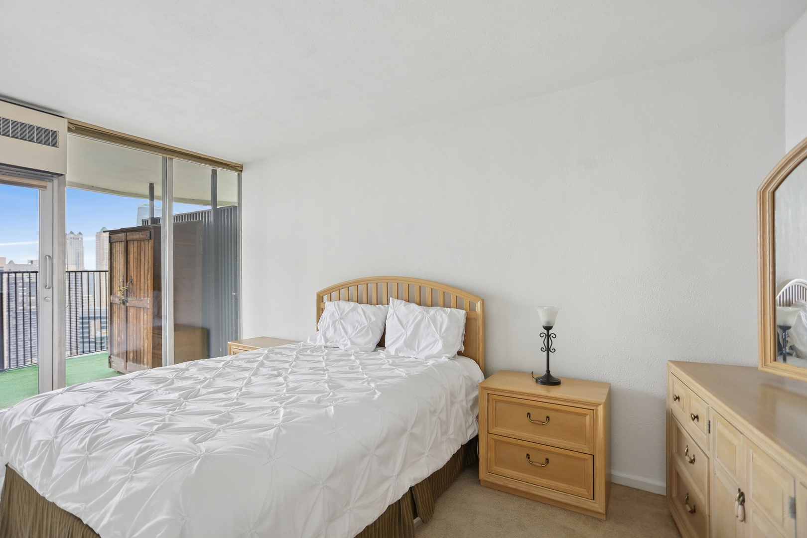 300 North State Street, Unit 5803 Chicago, IL 60654 - Photo 5 of 18 a bedroom with a bed and a closet