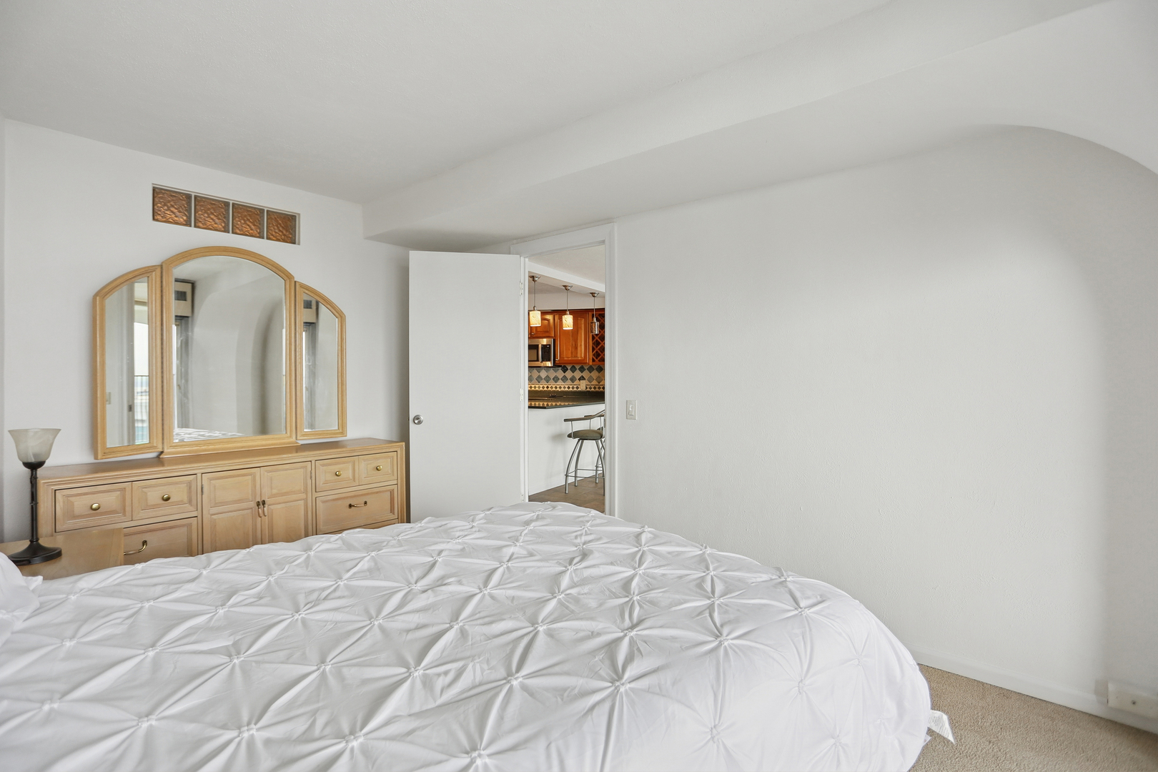 300 North State Street, Unit 5803 Chicago, IL 60654 - Photo 6 of 18 a bedroom with a bed and a dresser