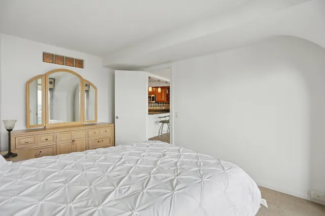 a bedroom with a bed and a dresser