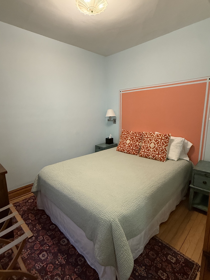 2134 North Damen Avenue, Unit 2 Chicago, IL 60647 - Photo 12 of 22 a bedroom with a bed and a window