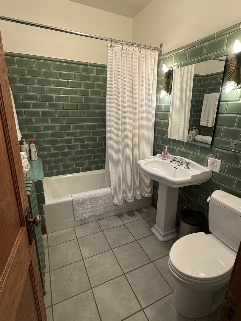 2134 North Damen Avenue, Unit 2 Chicago, IL 60647 - Photo 14 of 22 a bathroom with a sink toilet and shower