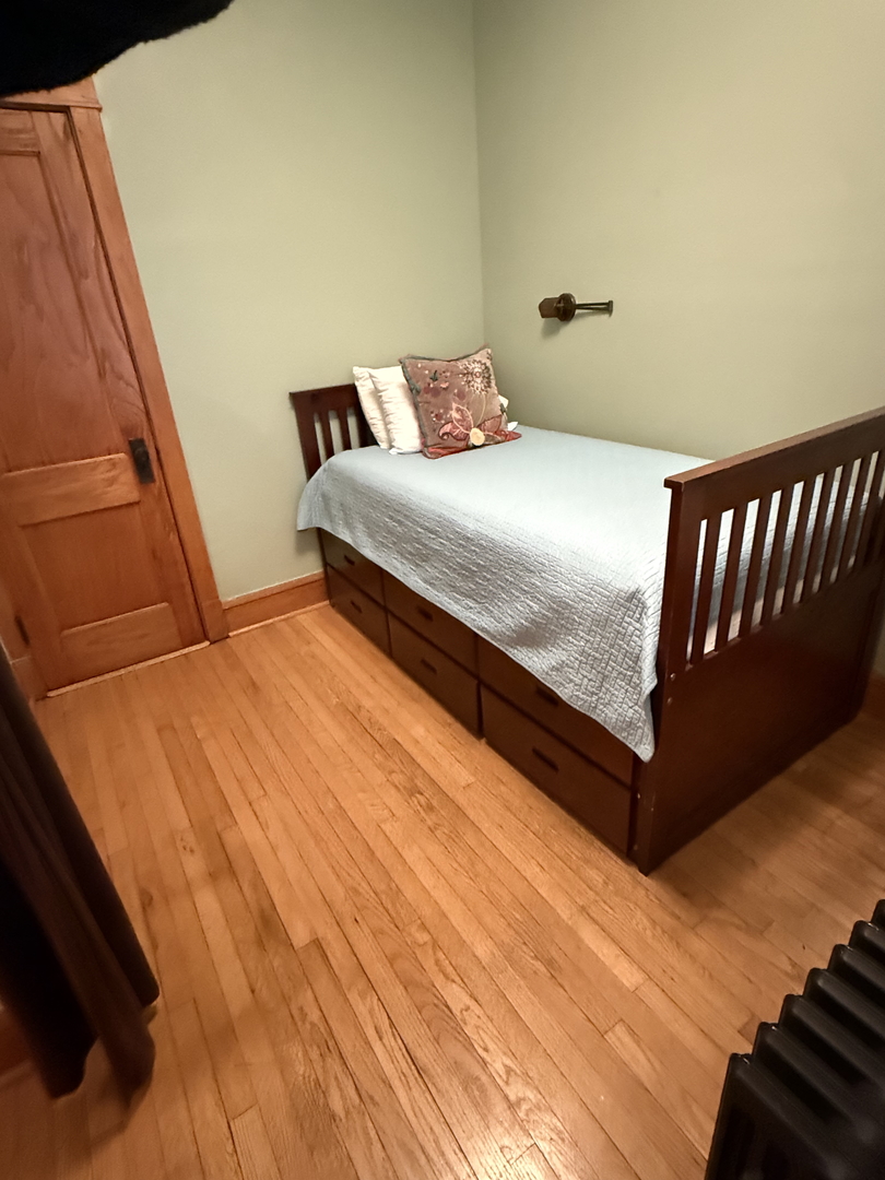 2134 North Damen Avenue, Unit 2 Chicago, IL 60647 - Photo 18 of 22 a bedroom with a bed and wooden floor