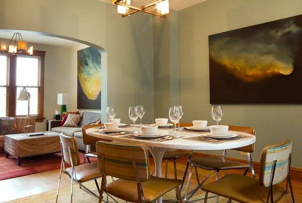 a dining room with furniture and wooden floor