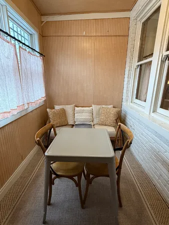 a view of a room with furniture and a window