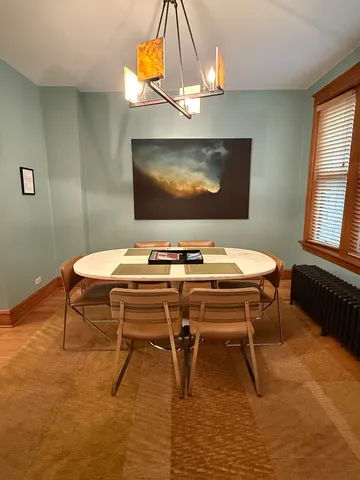 a dining room with furniture and window