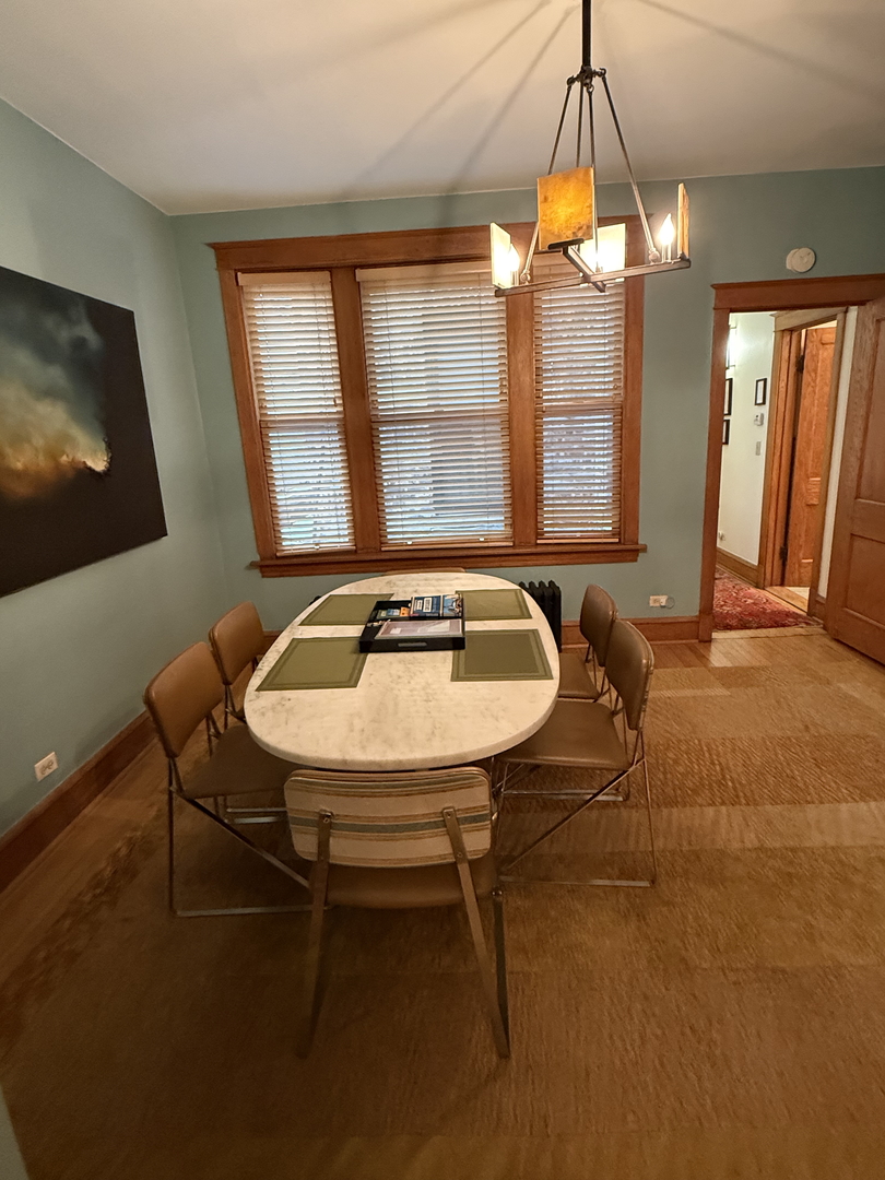 2134 North Damen Avenue, Unit 2 Chicago, IL 60647 - Photo 8 of 22 a view of a dining room with furniture window and outside view