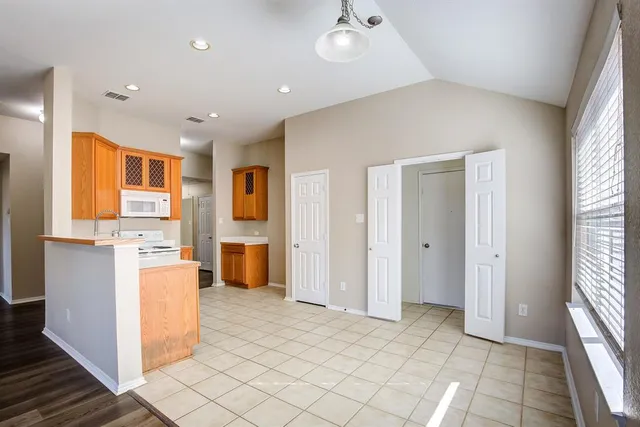 a view of a kitchen with furniture and an open kitchen