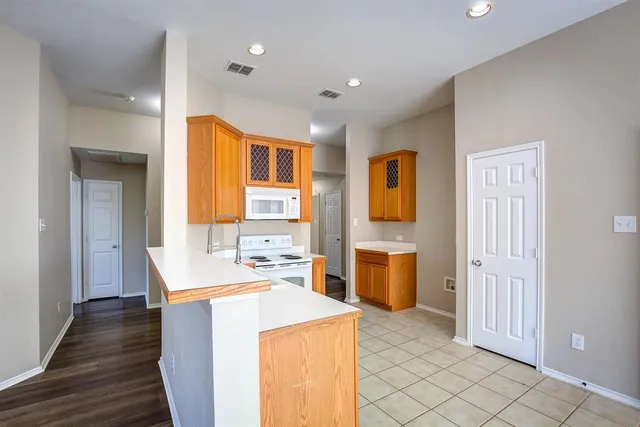 a view of a kitchen with a sink dishwasher and a refrigerator