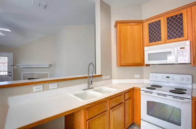 a kitchen with a sink stove and microwave