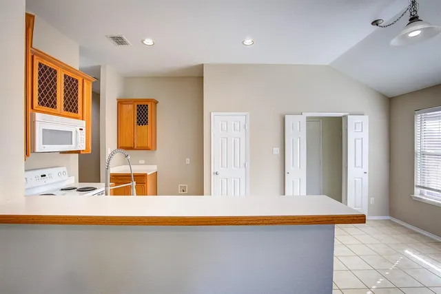 a view of a kitchen with furniture and staircase