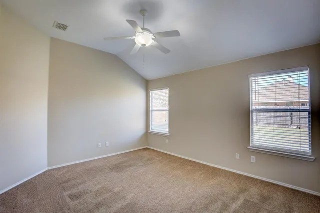 a view of a livingroom with a ceiling fan and a chandelier fan