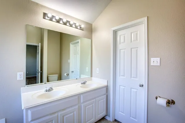 a bathroom with a tub sink toilet and shower