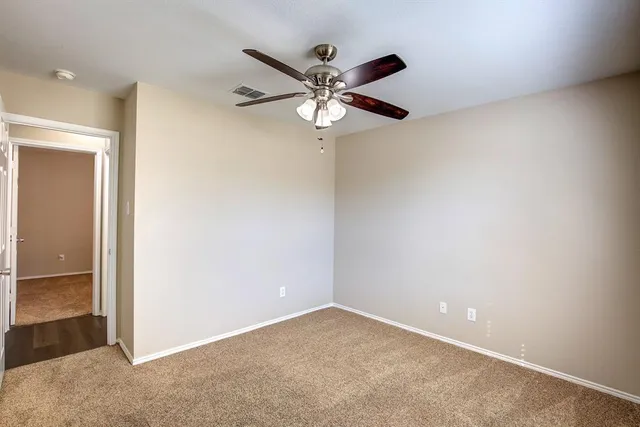a view of an empty room with a fan