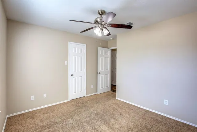 a a chandelier fan and window in a room