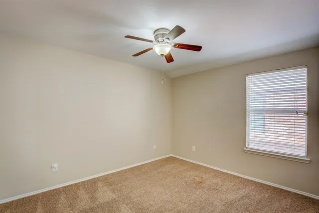 an empty room with closet and windows