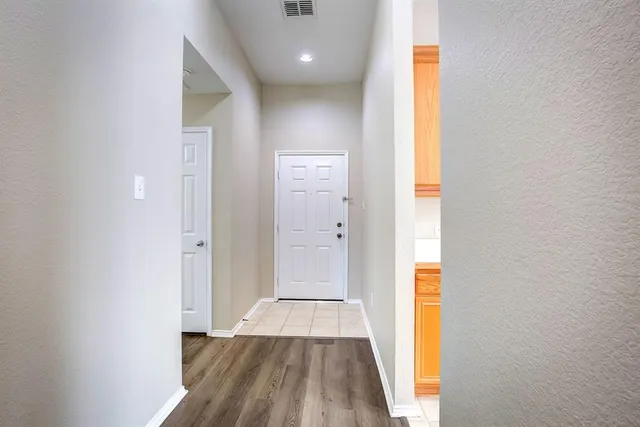 a view of a hallway with wooden floor