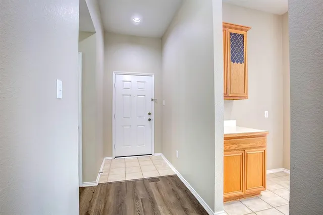 a view of a hallway with wooden floor and closet