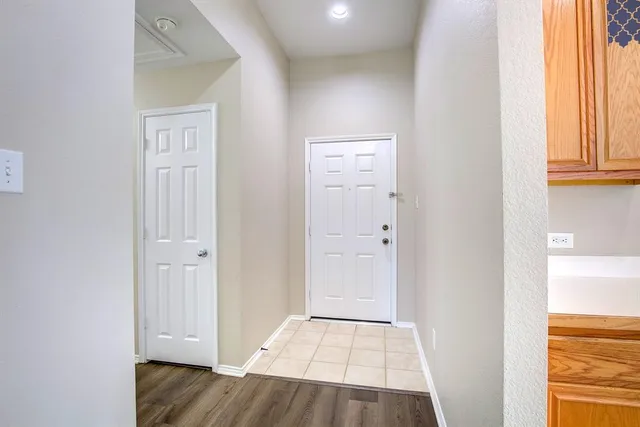 a view of an entryway with wooden floor