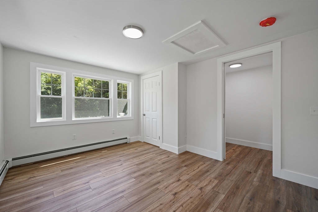 282 Parker Road Barnstable, MA 02668 - Photo 11 of 17 an empty room with wooden floor and windows