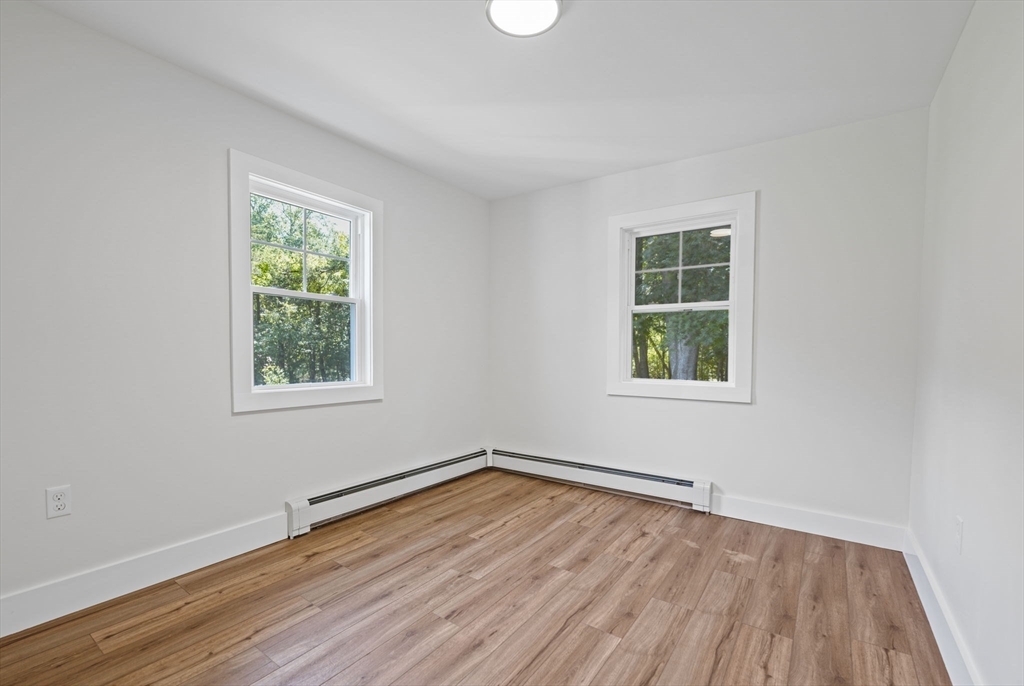 282 Parker Road Barnstable, MA 02668 - Photo 13 of 17 an empty room with wooden floor and windows