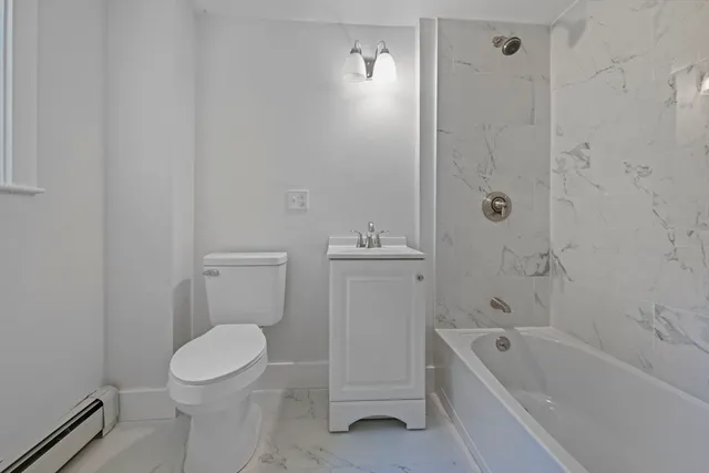 a bathroom with a toilet a sink and bathtub