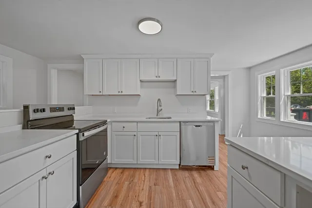a kitchen with cabinets oven and a dishwasher