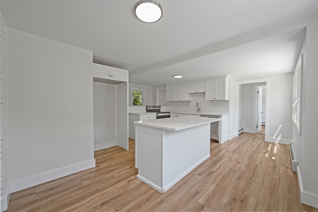 282 Parker Road Barnstable, MA 02668 - Photo 3 of 17 a kitchen with wooden floors and white walls