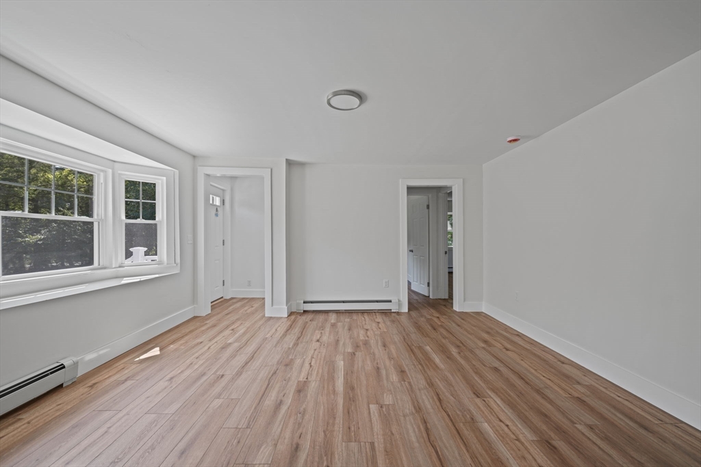 282 Parker Road Barnstable, MA 02668 - Photo 7 of 17 a view of an empty room with wooden floor and a window