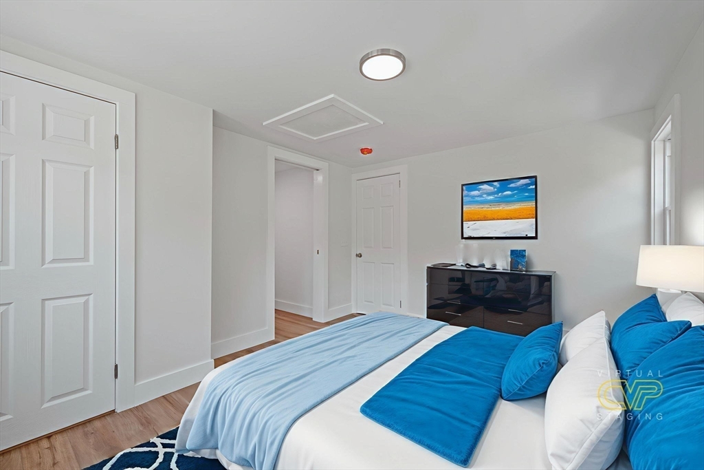 282 Parker Road Barnstable, MA 02668 - Photo 10 of 17 a bedroom with a bed and dresser with wooden floor