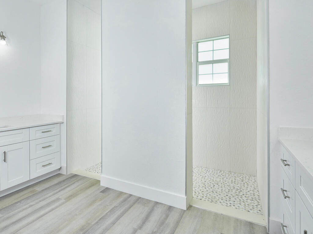 3677 Oil Well Road Naples, FL 34120 - Photo 11 of 28 an empty room with cabinet wooden closet and windows