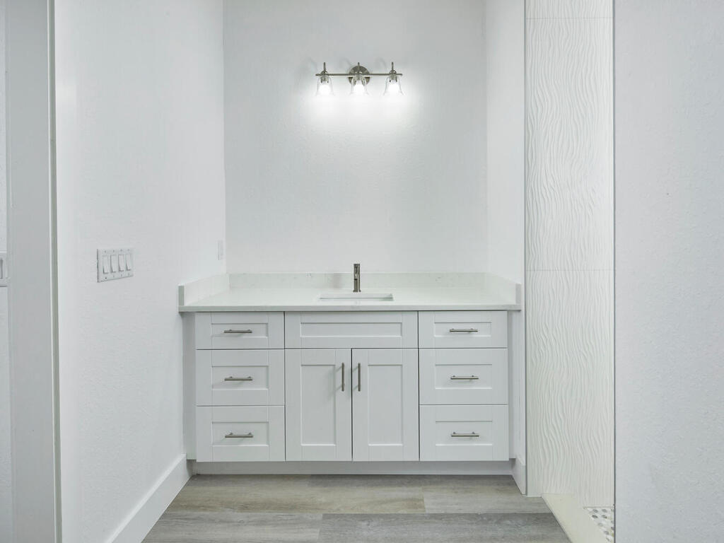3677 Oil Well Road Naples, FL 34120 - Photo 12 of 28 a bathroom with a sink vanity and mirror