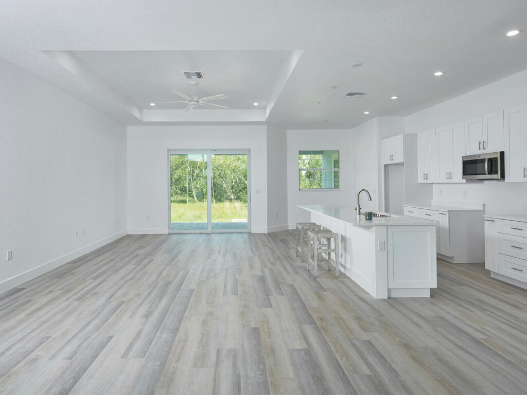 3677 Oil Well Road Naples, FL 34120 - Photo 5 of 28 a view of a kitchen with wooden floor and a window