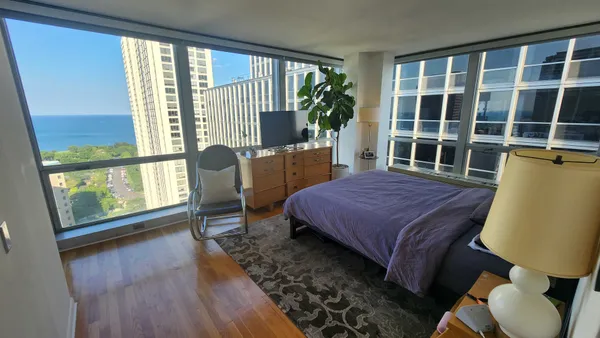 a bedroom with a bed and wooden floor