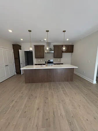 a kitchen with stainless steel appliances granite countertop a sink stove and cabinets