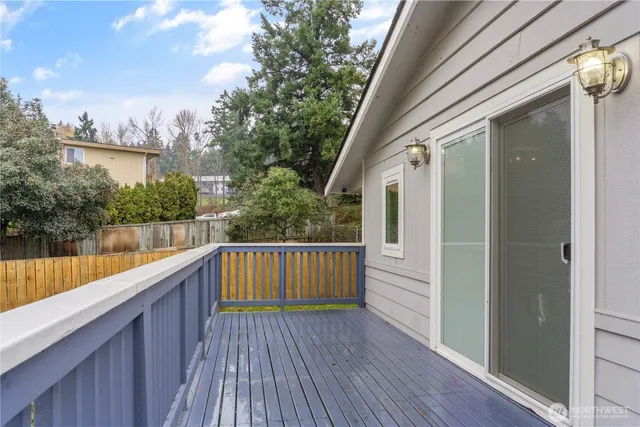 a view of balcony with wooden floor and fence