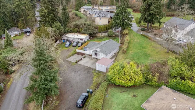 an aerial view of a house with a yard basket ball court and outdoor seating