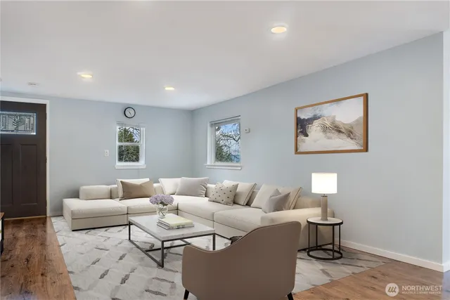 a living room with furniture a rug and a window