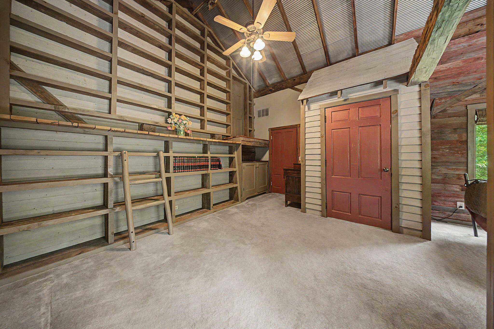 9766 Sullivan Road Union, KY 41091 - Photo 16 of 50 The primary bedroom houses its own library with shelves ready to be filled with your favorite books or trinkets and treasures. Access the cat walk through the book shelves.