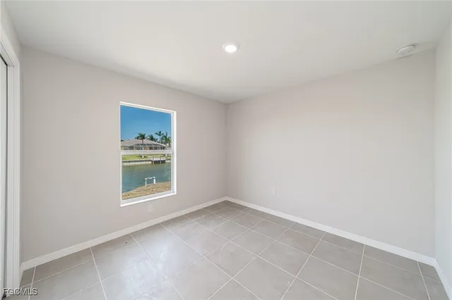 a view of kitchen and kitchen with granite countertop white cabinets